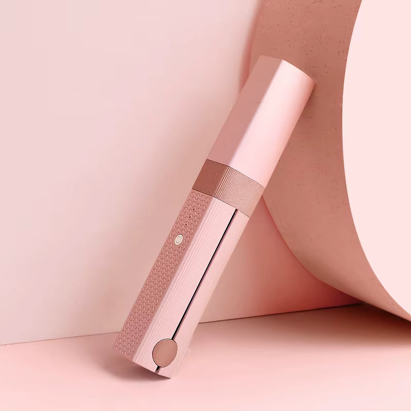 Rose gold electronic device on a pink background